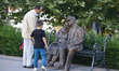 A man and a boy look at a statue in the historic Hamamonu district of Ankara, Turkey on Se...