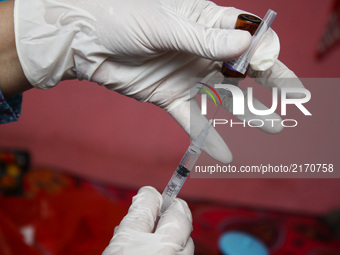 Health officers preparing the Measles Rubella vaccine before immunization in Bekasi, West Java, on September 8, 2017. The Indonesian governm...