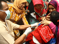 Health officers injected the Measles Rubella vaccine to children at an integrated health service post in Wanasari Village, West Java, on Sep...