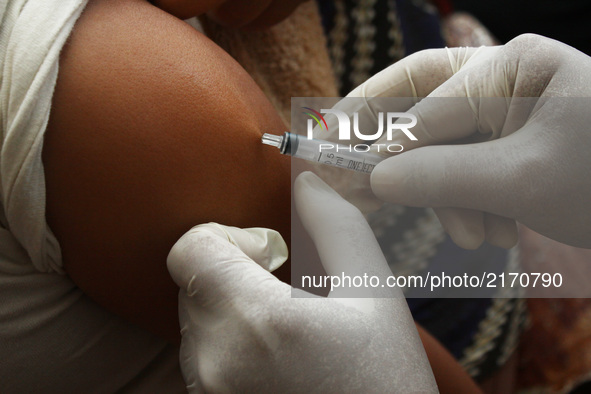 Health officers injected the Measles Rubella vaccine to children at an integrated health service post in Wanasari Village, West Java, on Sep...