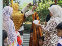 Parents enthusiastically took their children to be given immunization of Measles and Rubella (MR) vaccine at an integrated health service po...