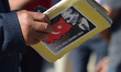 A man holds a book during a march marking the 94th anniversary of the main opposition Repu...