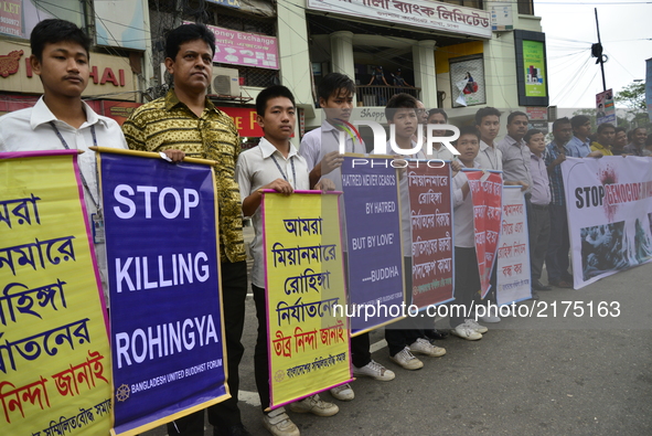 Bangladesh United Buddhist Forum activist hold up Placard during protest rally demanding stop violence on Rohingya in Myanmar near Myanmar E...