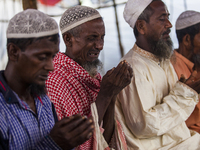 Rohingya Muslim refugees taking Asar prayer at a temporary makeshift shelter after crossing over from Myanmar into the Bangladesh side of th...