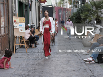 A model parades with design by Maria Lafuente during the MFW - Madrid Fashion Week in the street of the neighborhood of La Latina. September...