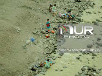 Residents take water, bathe, and wash the Cipamingkis river clothes that begin to recede, Cibarusah, Bekasi, West Java on September 13, 2017...