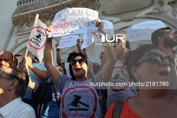 A female protester shouts slogans as she raises a placard that reads "we go back to the street, we don't forgive" during a rally held by the...