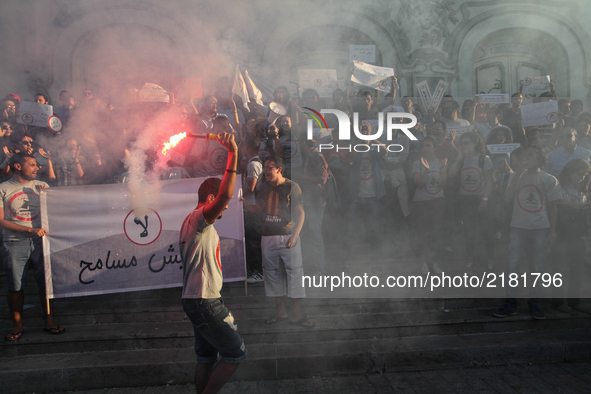 A protester holds a smoke grenade during a rally held by the movement "I don't forgive" (Manich Msameh: Arabic) on September 12, 2017, in Av...
