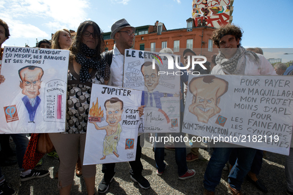 Protesters pose with several caricatures depicting Emmanuel MacronMore than 10000 protesters took to the streets of Toulouse against the new...