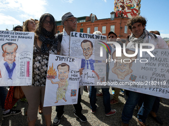 Protesters pose with several caricatures depicting Emmanuel MacronMore than 10000 protesters took to the streets of Toulouse against the new...
