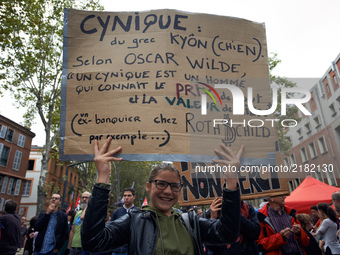 A student poses with a placard reading 'A cynic knows everything' price but the worth of nothing' citing Oscar Wilde.More than 10000 protest...