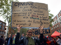 A student poses with a placard reading 'A cynic knows everything' price but the worth of nothing' citing Oscar Wilde.More than 10000 protest...