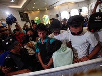Lina and Eduardo Gabriel De Guzman, parents of slain teenager Reynaldo De Guzman, is joined by family members during funeral rites in suburb...