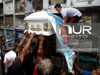 The body of slain teenager Reynaldo De Guzman is laid to rest at a cemetery during funeral rites in suburban Pasig City, east of Manila, Phi...