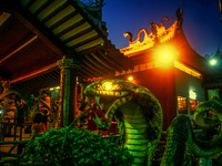 The lighting decoration of altar at night is the entertainment for ghosts is seen inside the Snake temple during Hungry ghost festivals in T...