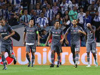 Besiktas' midfielder Talisca (R) celebrates after scoring a goal during the FC Porto v Besiktas - UEFA Champions League Group G round one ma...