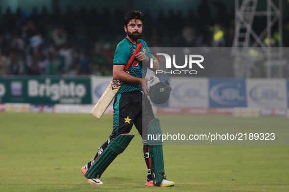 Pakistani batsman Ahmed Shahzad walks back to pavilion after his dismissal after 88 runs during the third and final Twenty20 International m...