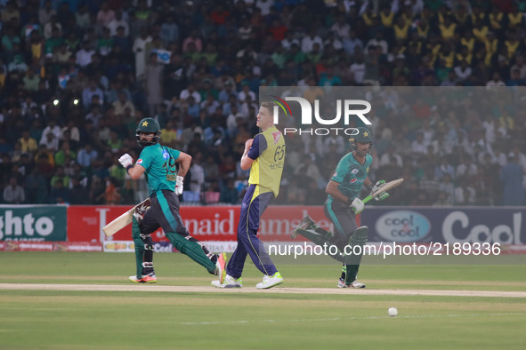 Pakistani batsmen Fakhar Zaman (R) and Ahmed Shahzad run between the wicket during the third and final Twenty20 International match between...
