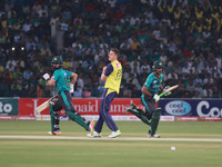 Pakistani batsmen Fakhar Zaman (R) and Ahmed Shahzad run between the wicket during the third and final Twenty20 International match between...
