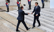 French President Emmanuel Macron (R) welcomes former French President Francois Hollande (L...