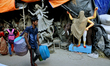 Indian hawker cross the street at the artisan's village of Kumartoli in Kolkata on Septemb...