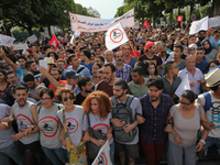 Protesters wave Tunisian flags and shout slogans during a march held under the slogan ‘firmness against the mafia regime’ by the movement "I...