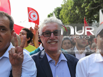 Hamma Hammami (C), spokesman of Popular Front, makes a victory sign as he attends a march held under the slogan ‘firmness against the mafia...