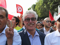 Hamma Hammami (C), spokesman of Popular Front, makes a victory sign as he attends a march held under the slogan ‘firmness against the mafia...