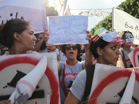 A female protester shout slogans as she raises a placard that reads “Youssef Chahed you are a traitor and enemy of the people” during a marc...