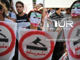 Female protesters wearing masks during a march held under the slogan ‘firmness against the mafia regime’ by the movement "I don't forgive" (...