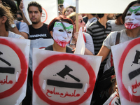 Female protesters wearing masks during a march held under the slogan ‘firmness against the mafia regime’ by the movement "I don't forgive" (...