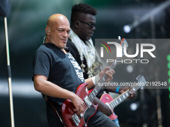 Guitarist Izo Diop (L) of French band Trust performs at the Festival of Humanity (Fete de l'Humanite), a political event and music festival...