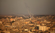 Smoke trails are seen as rockets are launched from the Gaza Strip towards Israel on August...