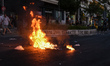 Fire burning in front of a grafitti "Pavlos is alive, smash the Nazis" in Keratsini, Greec...