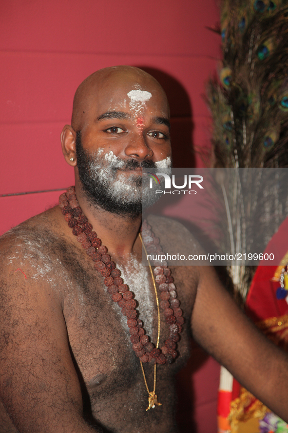 Tamil Hindu devotee covered with holy ash after ritual facial skewers were removed during the Vinayagar Ther Thiruvizha Festival in Ontario,...