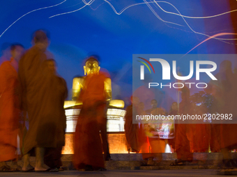In this long exposure photograph, Monks from Myanmar residing in Sri Lanka engage in a peaceful demonstration to show solidarity with Buddhi...