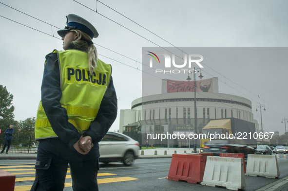 A female police officer is seen near the renonwn opera building in Bydoszcz, Poland on September 22, 2017. 