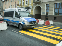 A police van is seen driving near a makeshift pedestrian crossing on one of the citys busiest roads on World Car-Free Day on September 22, 2...