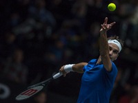 Team Europe player Roger Federer of Switzerland serves against Team World player Sam Querrey of United States during the second day at Laver...