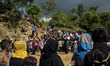 Rohingya refugee man and women wait for food aid at the Balukhali refugee camp in Ukhiya,...