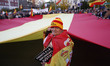 A protestor holds a huge spanish flag during a protest against the non-application of the...