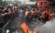 Palestinians gather around the remains of a car, which witnesses said was hit by an Israel...