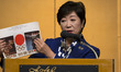 Tokyo Governor Yuriko Koike shows a book about the 1964 Tokyo Olympics during the Project...