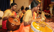 Tamil Hindu girls perform a devotional song on the veena during a Carnatic music program i...