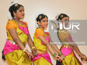 Bharatnatyam dancers practice an expressive dance backstage before a performance at a Tamil Hindu temple in Ontario, Canada. (