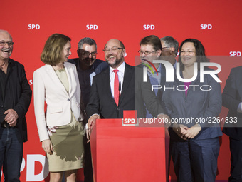 Chairman of the German Social Democratic Party (SPD) Martin Schulz (C) speaks after the announcement of a first projection of the election r...