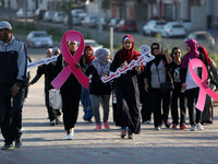 Palestinian women march on a street demonstration and carrying signs reading in Arabic ''Upright, walk'' (C-F), ''restore your youth by walk...