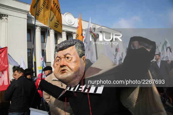 A man wears the mask of Petro Poroshenko during a rally in front of Ukrainian Parliament. Mikheil Saakashvili gathers few thousands to rally...