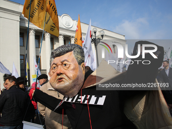 A man wears the mask of Petro Poroshenko during a rally in front of Ukrainian Parliament. Mikheil Saakashvili gathers few thousands to rally...
