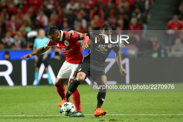 Benfica's Argentine midfielder Eduardo Salvio (R ) fights for the ball with Manchester United's Armenian midfielder Henrikh Mkhitaryan durin...